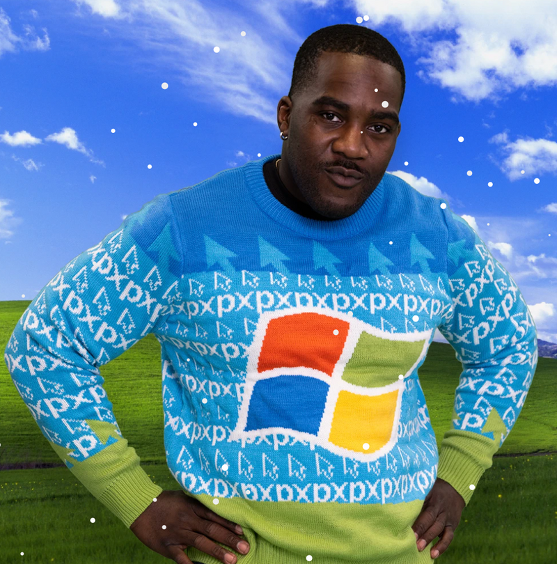 Man wearing Roody's custom Windows XP knitted Christmas sweater, featuring the classic four-color Windows logo and a repeating pixel pattern in blue and green.