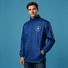 Load image into Gallery viewer, A man wearing a royal blue lightweight zip-up windbreaker jacket with a white circular chest logo, standing against a solid blue studio background.
